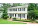 Inviting two-story home with black shutters, complemented by a well-manicured lawn and garden at 304 Ramblewood Dr, Raleigh, NC 27609
