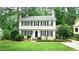 Charming two-story home with black shutters and beautifully landscaped front yard at 304 Ramblewood Dr, Raleigh, NC 27609