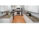 Modern kitchen with stainless steel appliances, granite counters, and hardwood floors at 304 Ramblewood Dr, Raleigh, NC 27609