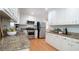 Bright kitchen features granite counters, white cabinets, and stainless steel appliances at 304 Ramblewood Dr, Raleigh, NC 27609