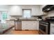 Modern kitchen with granite countertops, stainless steel appliances, and white cabinets at 304 Ramblewood Dr, Raleigh, NC 27609