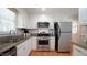 Bright kitchen features granite counters, white cabinets, and stainless steel appliances at 304 Ramblewood Dr, Raleigh, NC 27609