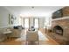 Spacious living room with a brick fireplace, comfortable seating, and plenty of light at 304 Ramblewood Dr, Raleigh, NC 27609