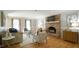 Comfortable living room featuring a brick fireplace, hardwood floors, and neutral decor at 304 Ramblewood Dr, Raleigh, NC 27609