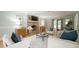 Inviting living room with brick fireplace, light-colored furnishings, and hardwood floors at 304 Ramblewood Dr, Raleigh, NC 27609