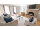 Bright living room featuring a brick fireplace, hardwood floors, and neutral furnishings at 304 Ramblewood Dr, Raleigh, NC 27609