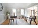 Bright home office with modern furniture, including a wood desk and accent chairs at 304 Ramblewood Dr, Raleigh, NC 27609
