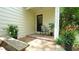 Outdoor patio with brick paving and chair sitting in the shade at 304 Ramblewood Dr, Raleigh, NC 27609