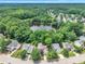 Aerial view of a residential area with a picturesque pond surrounded by lush greenery at 3101 Sawyers Mill Dr, Apex, NC 27539