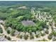Beautiful aerial view of homes surrounding a pond in a wooded neighborhood at 3101 Sawyers Mill Dr, Apex, NC 27539