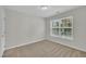 Neutral bedroom with a large window letting in natural light and tan carpet at 3101 Sawyers Mill Dr, Apex, NC 27539