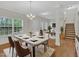 Bright dining room with chandelier, large table, and view into the living room at 3101 Sawyers Mill Dr, Apex, NC 27539