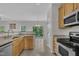 Spacious kitchen featuring granite countertops, stainless steel appliances, and great natural light at 3101 Sawyers Mill Dr, Apex, NC 27539