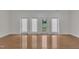 Bright living room with hardwood floors and access to the outside through glass-paned doors at 3101 Sawyers Mill Dr, Apex, NC 27539