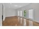 Bright living room with hardwood floors and access to the outside through glass-paned doors at 3101 Sawyers Mill Dr, Apex, NC 27539