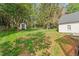 Large backyard with mature trees, shed, and ample space for recreation at 3129 Merrianne Dr, Raleigh, NC 27607