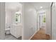 Hallway view to a white bathroom featuring modern fixtures and lighting at 3129 Merrianne Dr, Raleigh, NC 27607