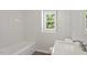 Bright bathroom featuring a tub, modern sink, and a window at 3129 Merrianne Dr, Raleigh, NC 27607