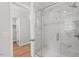Bathroom featuring a glass-enclosed shower with marble-look tile and modern fixtures at 3129 Merrianne Dr, Raleigh, NC 27607