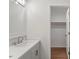 Bathroom featuring a single vanity with modern fixtures leading to a closet at 3129 Merrianne Dr, Raleigh, NC 27607