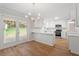 Bright kitchen features white cabinets, stainless appliances, and a door to the backyard at 3129 Merrianne Dr, Raleigh, NC 27607