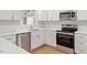 The renovated kitchen features white cabinets, stainless appliances, and subway tile backsplash at 3129 Merrianne Dr, Raleigh, NC 27607