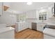 Bright, updated kitchen with quartz countertops, stainless steel appliances, and a view to the breakfast nook at 3129 Merrianne Dr, Raleigh, NC 27607