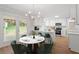 Bright eat-in kitchen features white cabinetry, stainless appliances, and a door to the backyard at 3129 Merrianne Dr, Raleigh, NC 27607