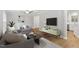 This staged living room features modern furniture, hardwood floors, and neutral paint at 3129 Merrianne Dr, Raleigh, NC 27607