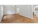 Spacious living room with luxury vinyl plank flooring, fresh paint, and a view into the modern kitchen at 3129 Merrianne Dr, Raleigh, NC 27607