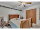 Comfortable bedroom features a ceiling fan, carpeted floors, and a spacious closet at 320 Bainbridge Cir, Garner, NC 27529