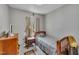 Bedroom with a single bed, carpeted floors, and a window with curtains at 320 Bainbridge Cir, Garner, NC 27529