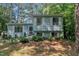 Charming split-level home featuring light blue siding, white shutters and a beautifully landscaped front yard at 320 Bainbridge Cir, Garner, NC 27529