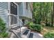 Front door and porch area of a light blue split-level home with white shutters and lush landscaping at 320 Bainbridge Cir, Garner, NC 27529