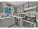 This eat-in kitchen features white countertops, stainless appliances, and a unique stained glass window at 320 Bainbridge Cir, Garner, NC 27529