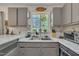 The kitchen offers a double sink and a decorative stained glass window for natural light at 320 Bainbridge Cir, Garner, NC 27529