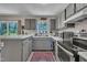 Functional kitchen featuring stainless appliances, white countertops, and a decorative flamingo window at 320 Bainbridge Cir, Garner, NC 27529