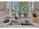 Close up of a stainless steel sink with flamingo stained glass window in the kitchen at 320 Bainbridge Cir, Garner, NC 27529