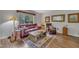Warm and inviting living room with hardwood floors, leather seating, and a decorative area rug at 320 Bainbridge Cir, Garner, NC 27529