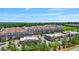 An aerial view of a commercial district featuring retail buildings and large apartment buildings against a lush, green backdrop at 341 View Dr, Morrisville, NC 27560