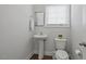 Simple half bathroom with pedestal sink, toilet, and wood look floors at 341 View Dr, Morrisville, NC 27560
