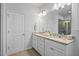 Well-lit bathroom features a double vanity with granite countertop and tiled floor at 341 View Dr, Morrisville, NC 27560