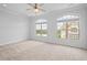 Bedroom featuring neutral carpet and arched windows overlooking trees at 341 View Dr, Morrisville, NC 27560