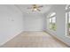 Bedroom featuring neutral carpet and arched windows overlooking trees at 341 View Dr, Morrisville, NC 27560