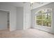 Carpeted bedroom features a large arched window and ceiling fan with light at 341 View Dr, Morrisville, NC 27560