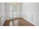 Bright foyer with hardwood floors, decorative wainscoting, and a glass-paneled front door, offering a welcoming entrance at 341 View Dr, Morrisville, NC 27560
