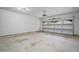 Spacious two-car garage featuring a concrete floor and windows at 341 View Dr, Morrisville, NC 27560