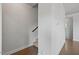 Hallway with hardwood floors, access to a staircase, and neutral paint at 341 View Dr, Morrisville, NC 27560