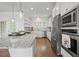 Bright kitchen features stainless steel appliances, granite counters, and center island at 341 View Dr, Morrisville, NC 27560