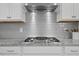 Stainless steel range and granite counters surrounded by white cabinets, perfect for cooking at 341 View Dr, Morrisville, NC 27560